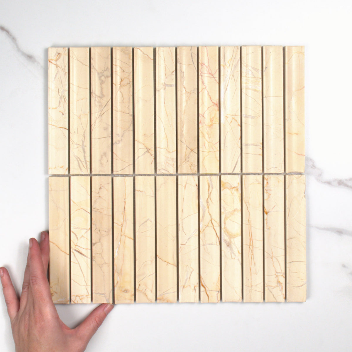 Elementa Cream Block Concave Mosaic 23x148mm top view, hand for scale