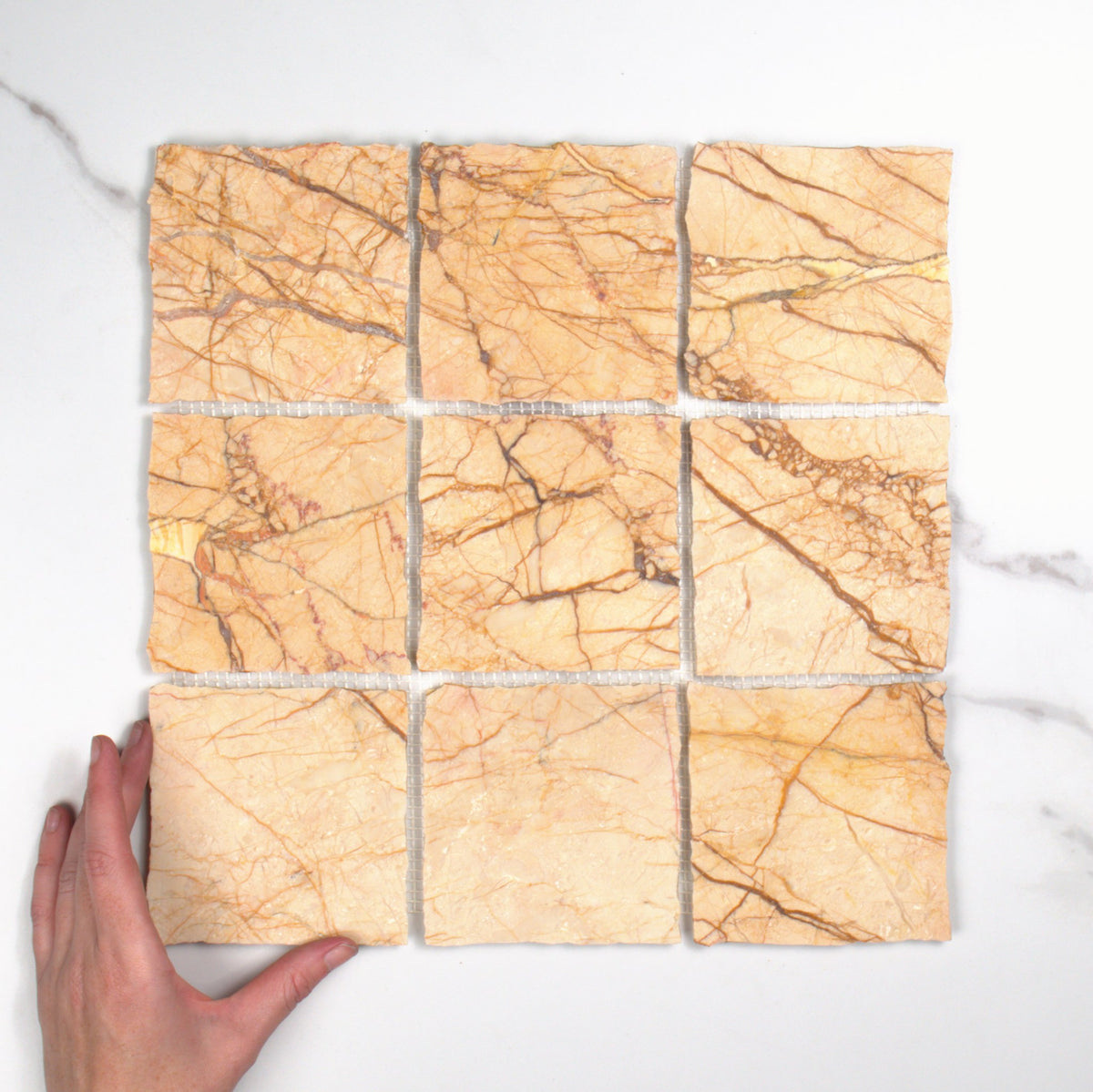 Elementa Cream Block Mosaic 100x100mm top view, hand for scale