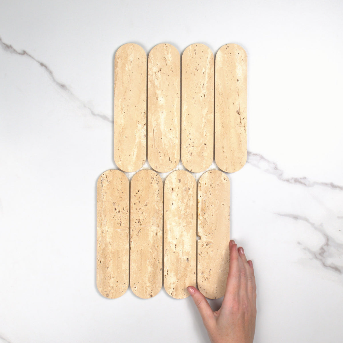 Elementa Travertine Ivory Cylinder Mosaic 50x198mm top view, hand for scale
