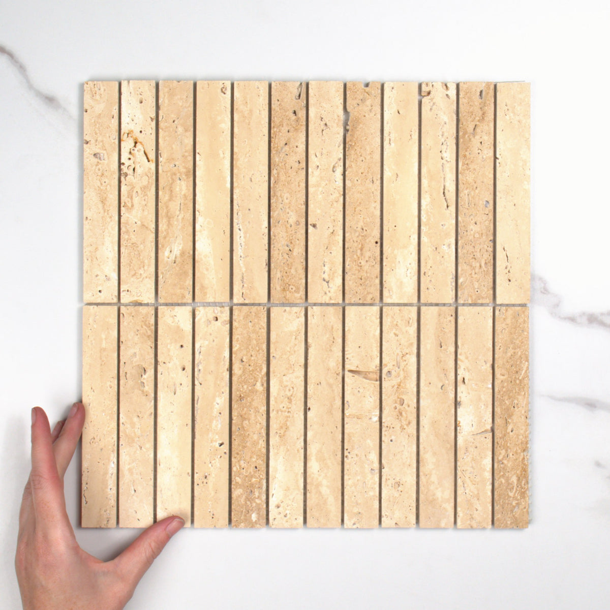 Elementa Travertine Ivory Finger Mosaic 23x148mm top view, hand for scale