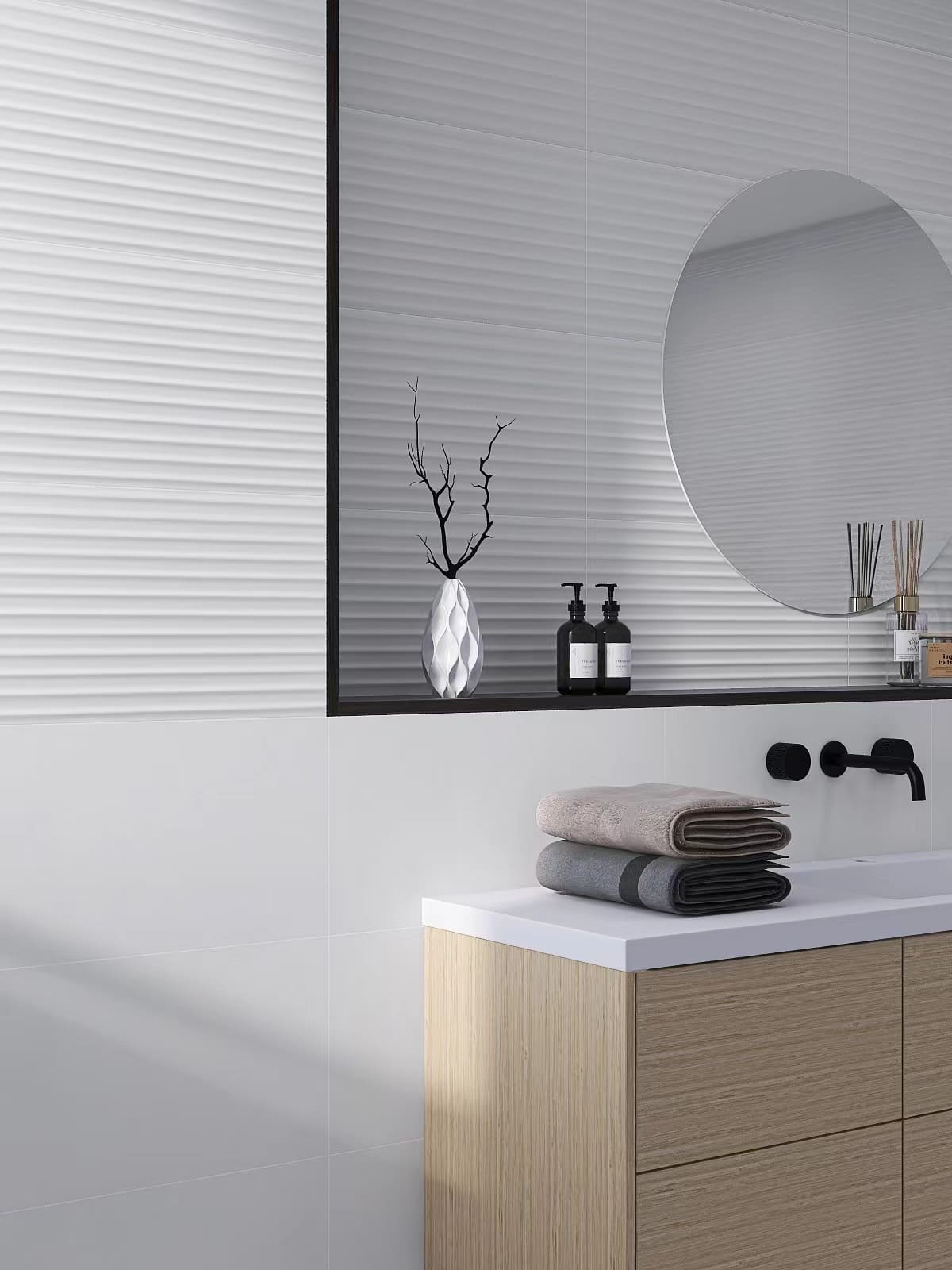 Fluted Matt White 300x600mm wall tiles installed in a modern bathroom with a round mirror, wood vanity unit, and black matte fixtures.