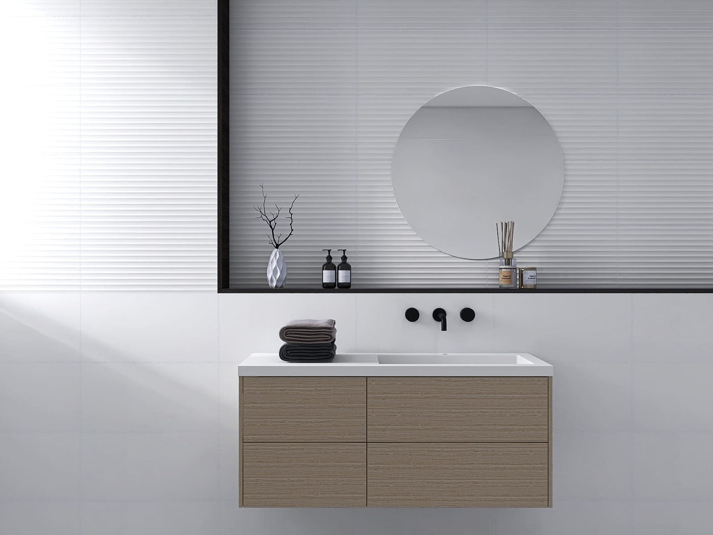 Fluted Matt White 300x600mm tiles installed as a textured bathroom feature wall behind a floating wood vanity unit and round mirror.