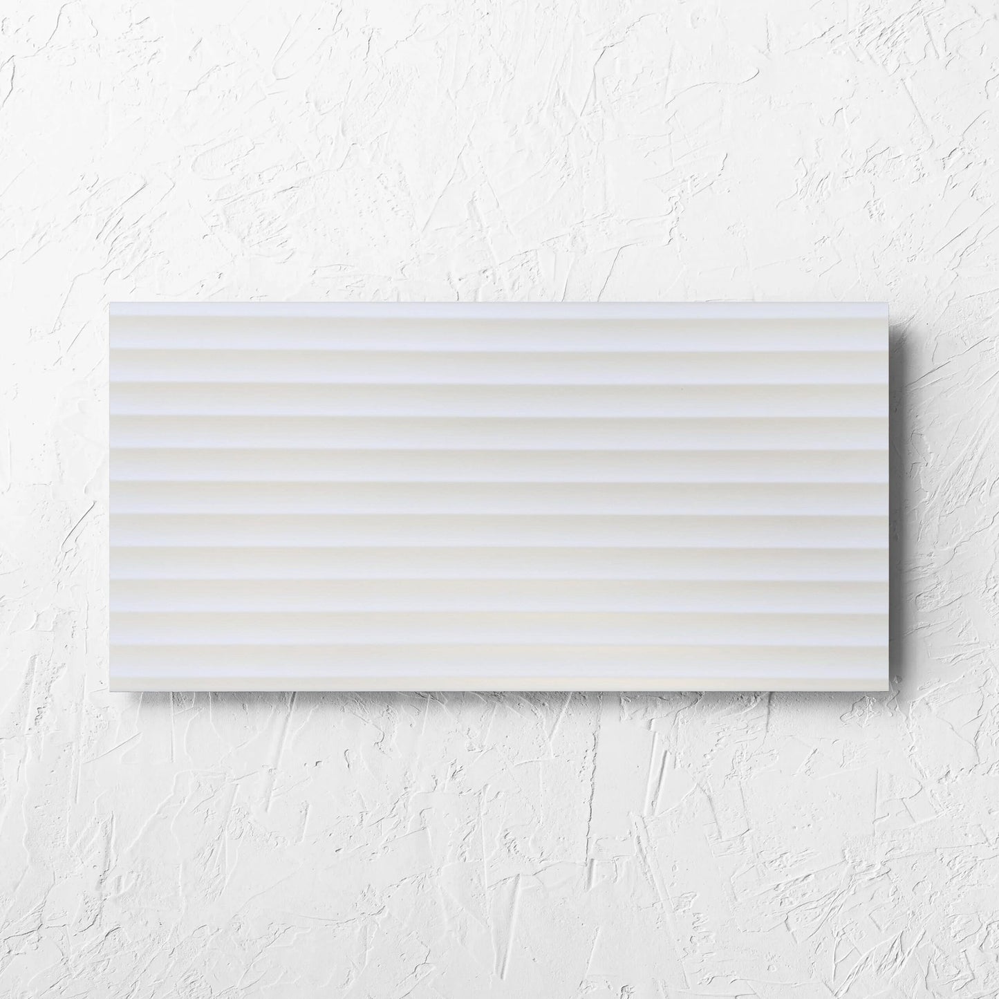 Fluted Matt White 300x600mm tile laid flat on a white rendered wall, showing the white matt surface