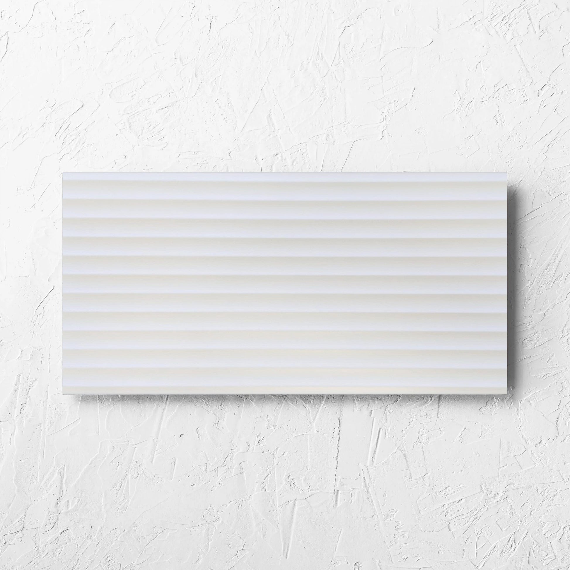 Fluted Matt White 300x600mm tile laid flat on a white rendered wall, showing the white matt surface