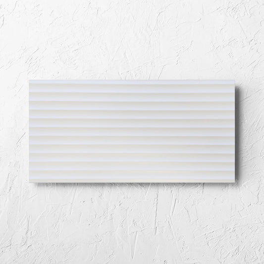 Fluted Matt White 300x600mm tile laid flat on a white rendered wall, showing the white matt surface