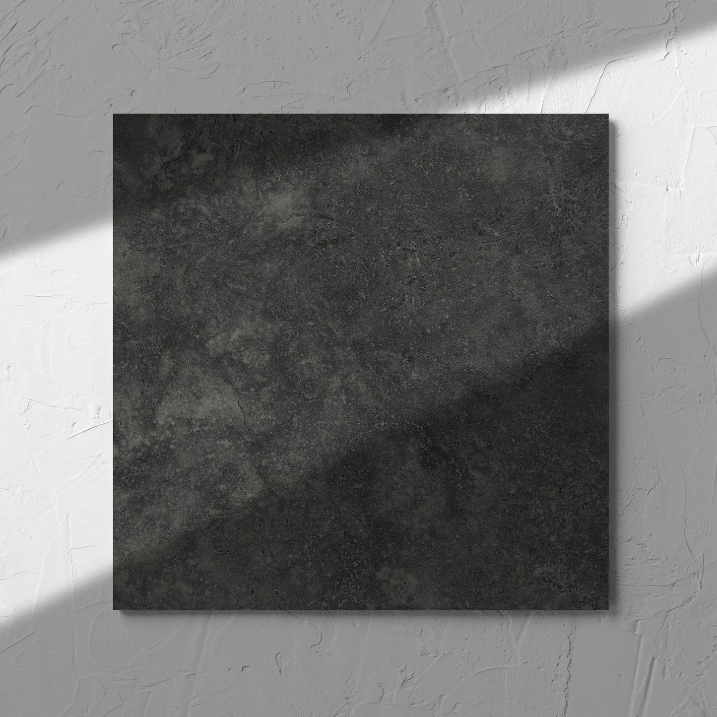 Fossil Stone Coal Matt 300x300mm tile in soft natural window light, showing the matt surface