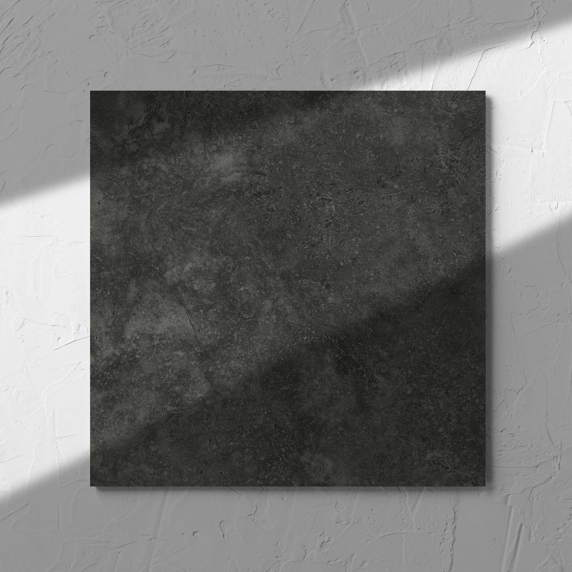 Fossil Stone Coal Matt 300x300mm tile in soft natural window light, showing the matt surface