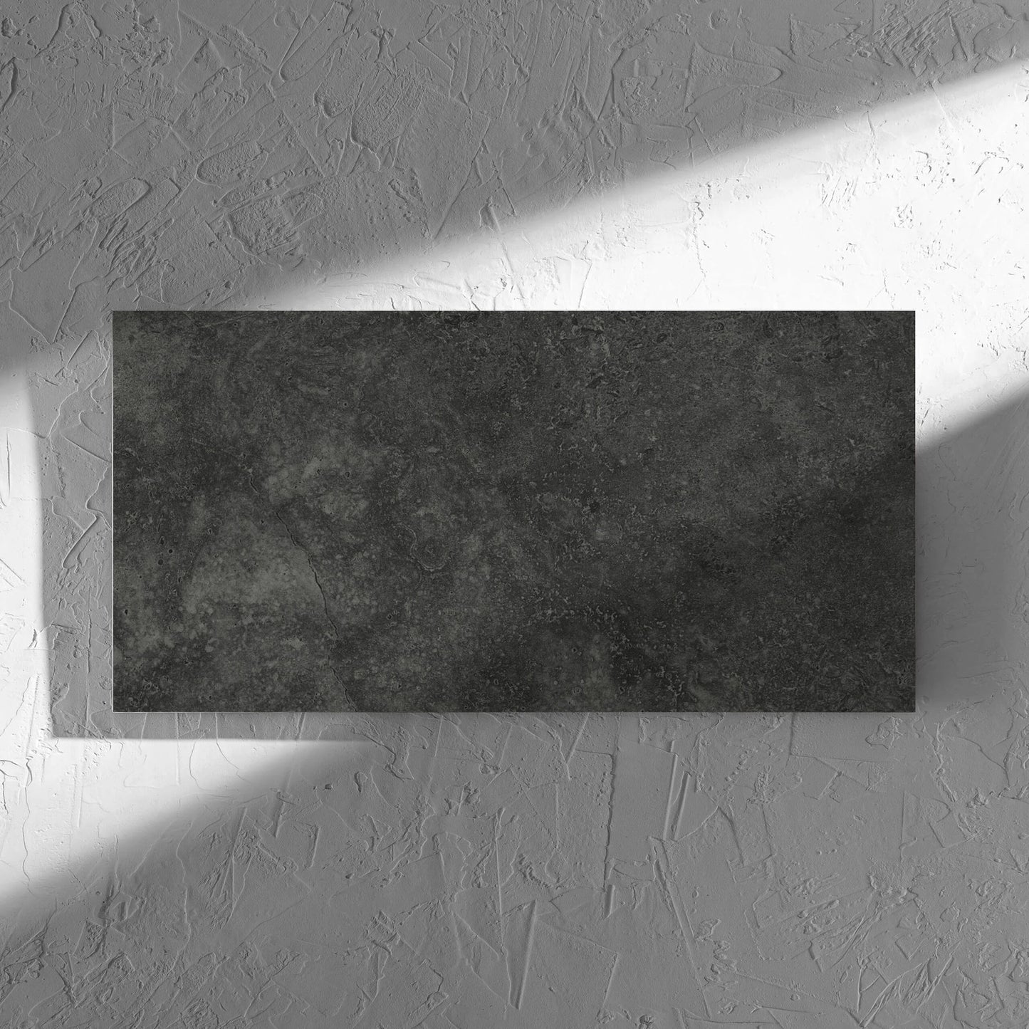 Fossil Stone Coal Matt 300x600mm tile in soft natural window light, showing the matt surface