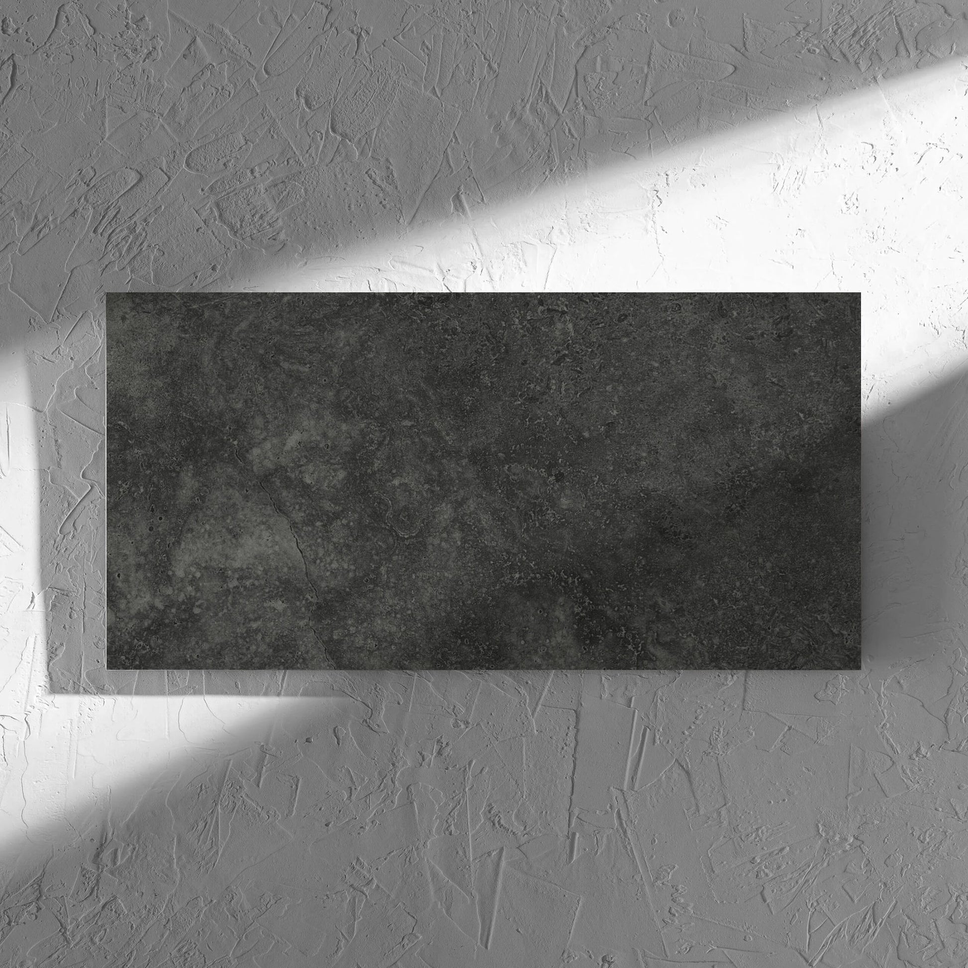 Fossil Stone Coal Matt 300x600mm tile in soft natural window light, showing the matt surface
