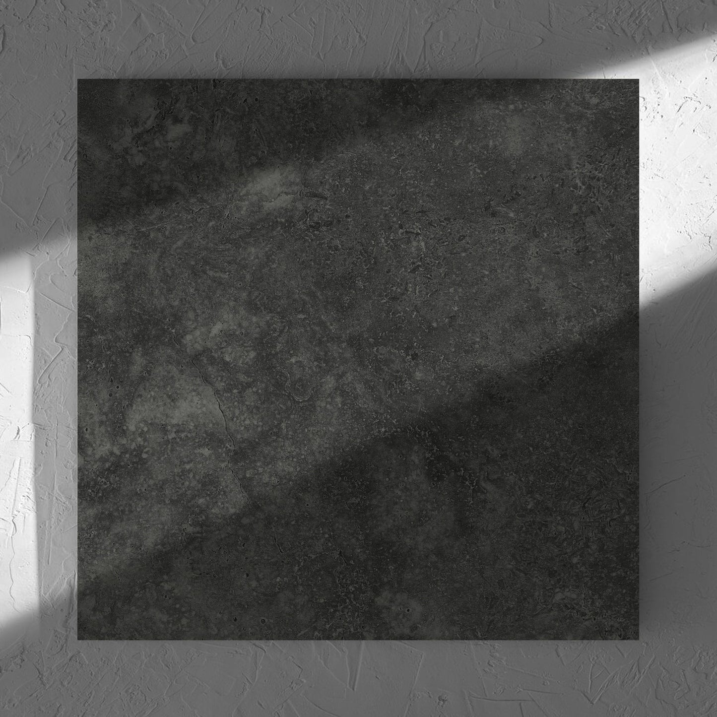 Fossil Stone Coal Matt 600x600mm tile in soft natural window light, showing the matt surface