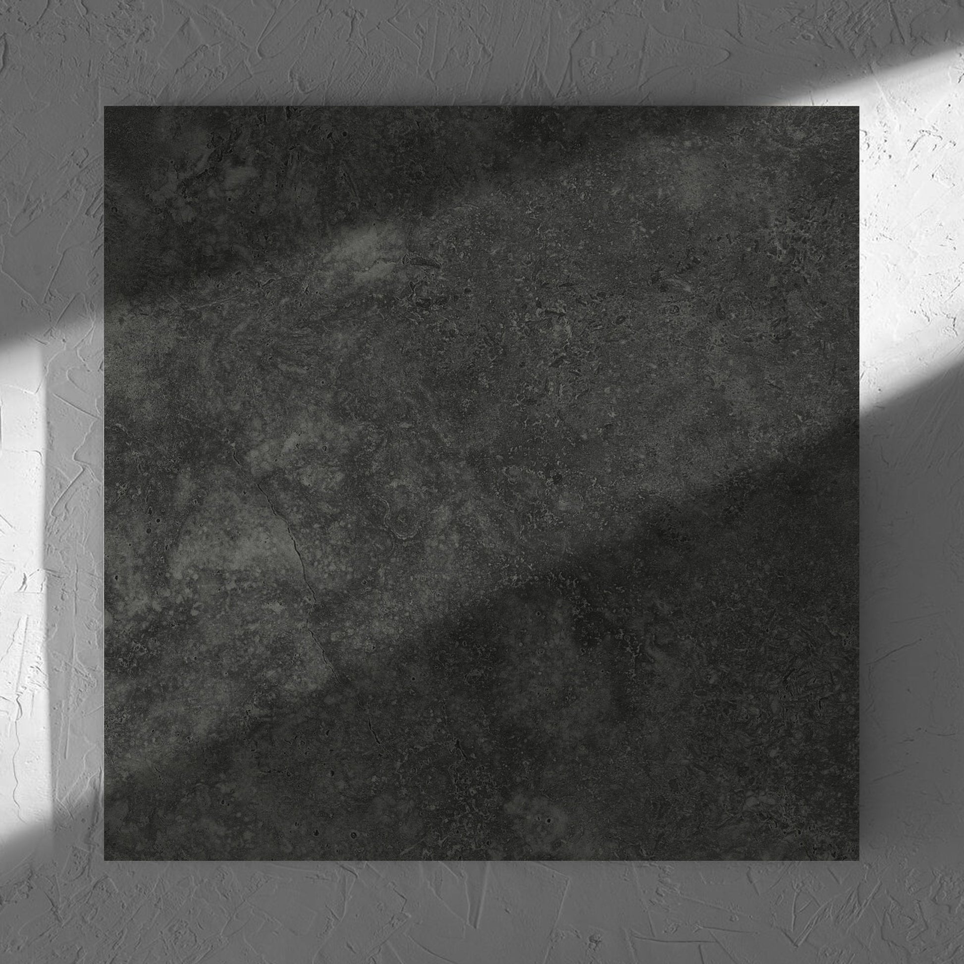 Fossil Stone Coal Matt 600x600mm tile in soft natural window light, showing the matt surface