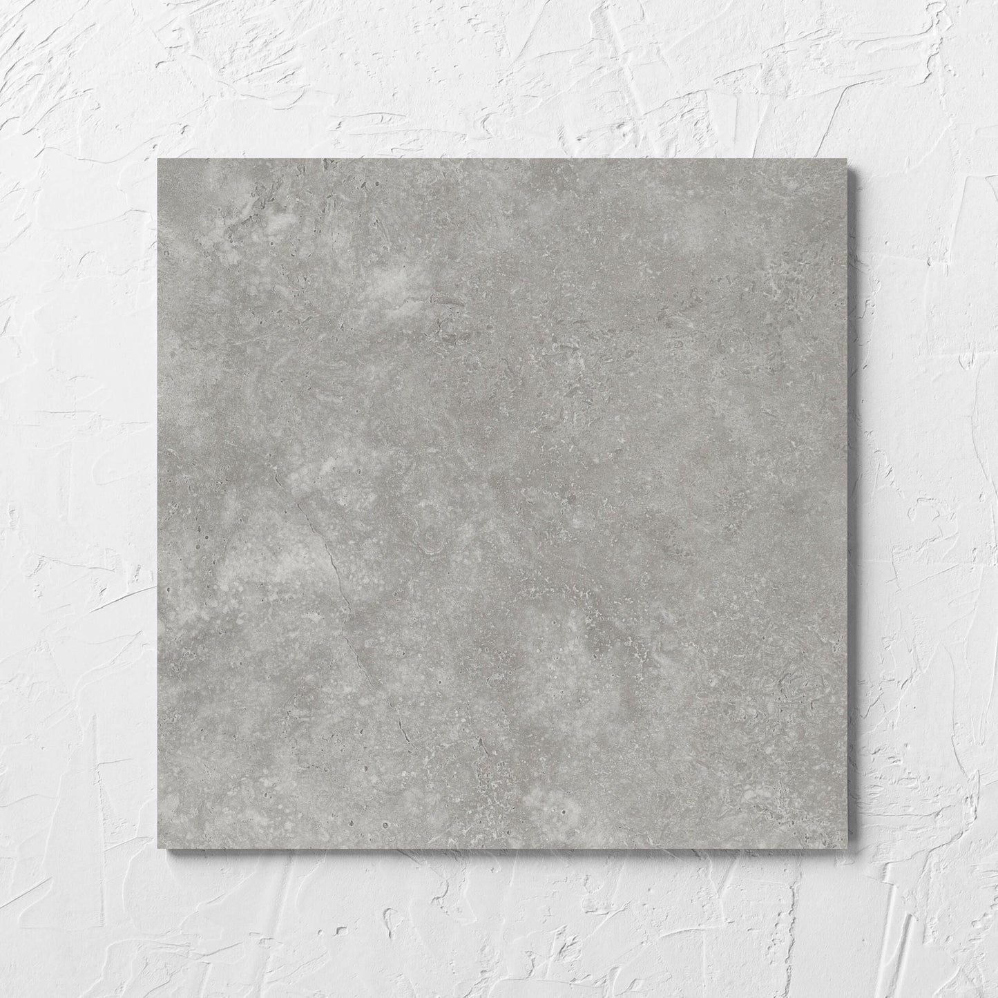 Fossil Stone Pebble Matt 300x300mm tile laid flat on a white rendered wall, showing the matt surface