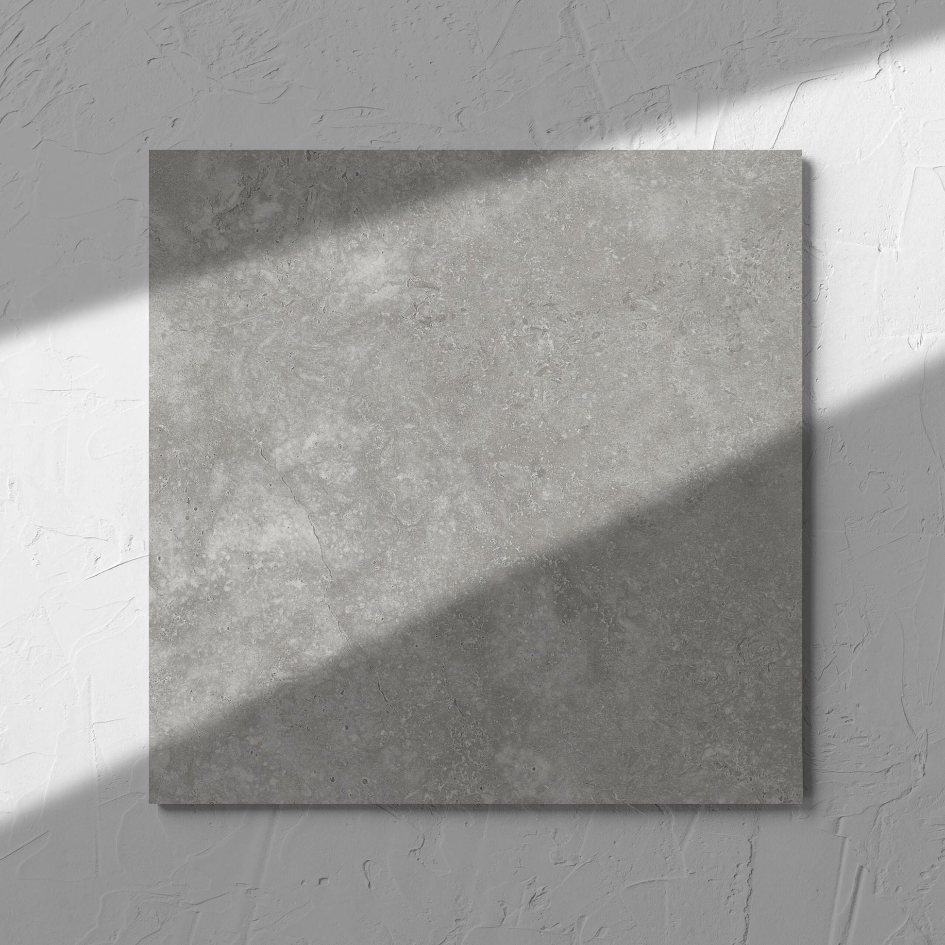 Fossil Stone Pebble Matt 300x300mm tile in soft natural window light, showing the matt surface