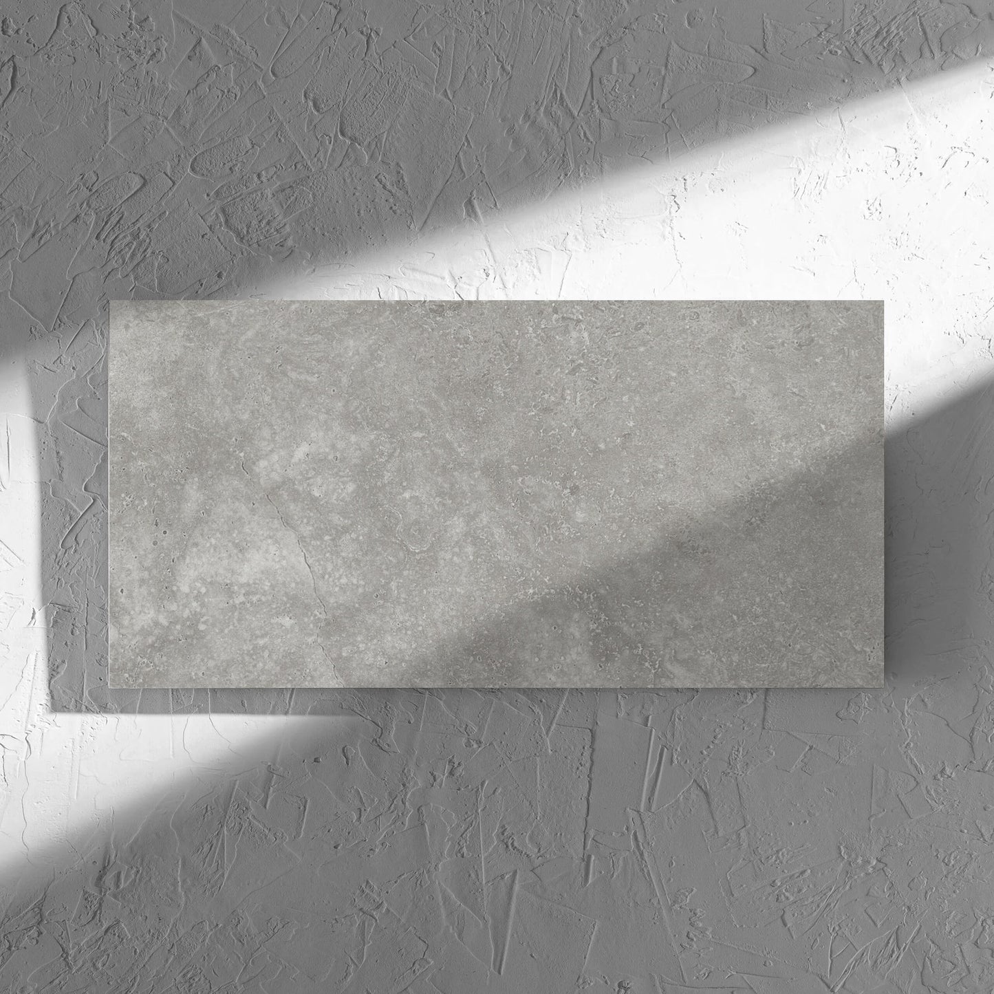 Fossil Stone Pebble Matt 300x600mm tile in soft natural window light, showing the matt surface