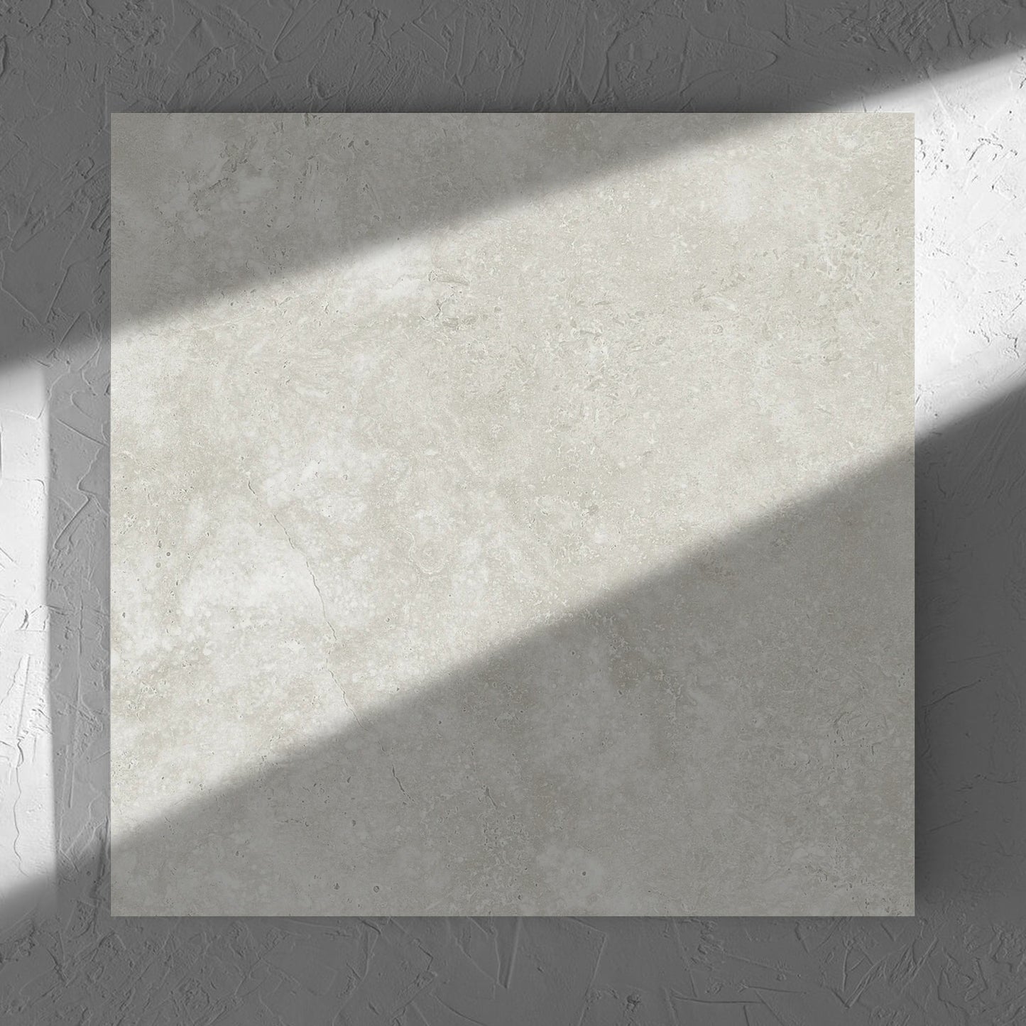 Fossil Stone Sand Matt 600x600mm tile in soft natural window light, showing the matt surface