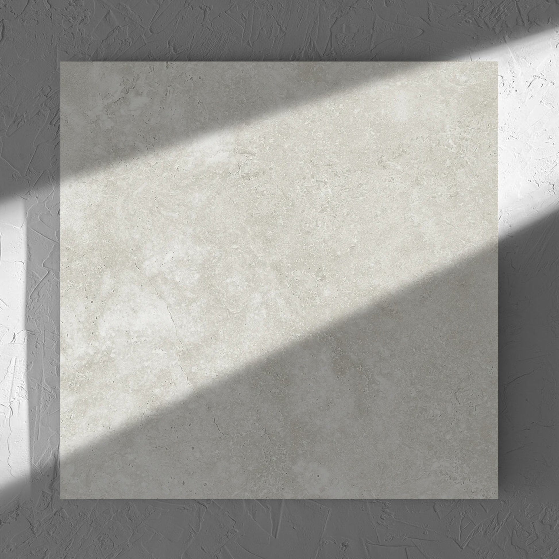 Fossil Stone Sand Matt 600x600mm tile in soft natural window light, showing the matt surface