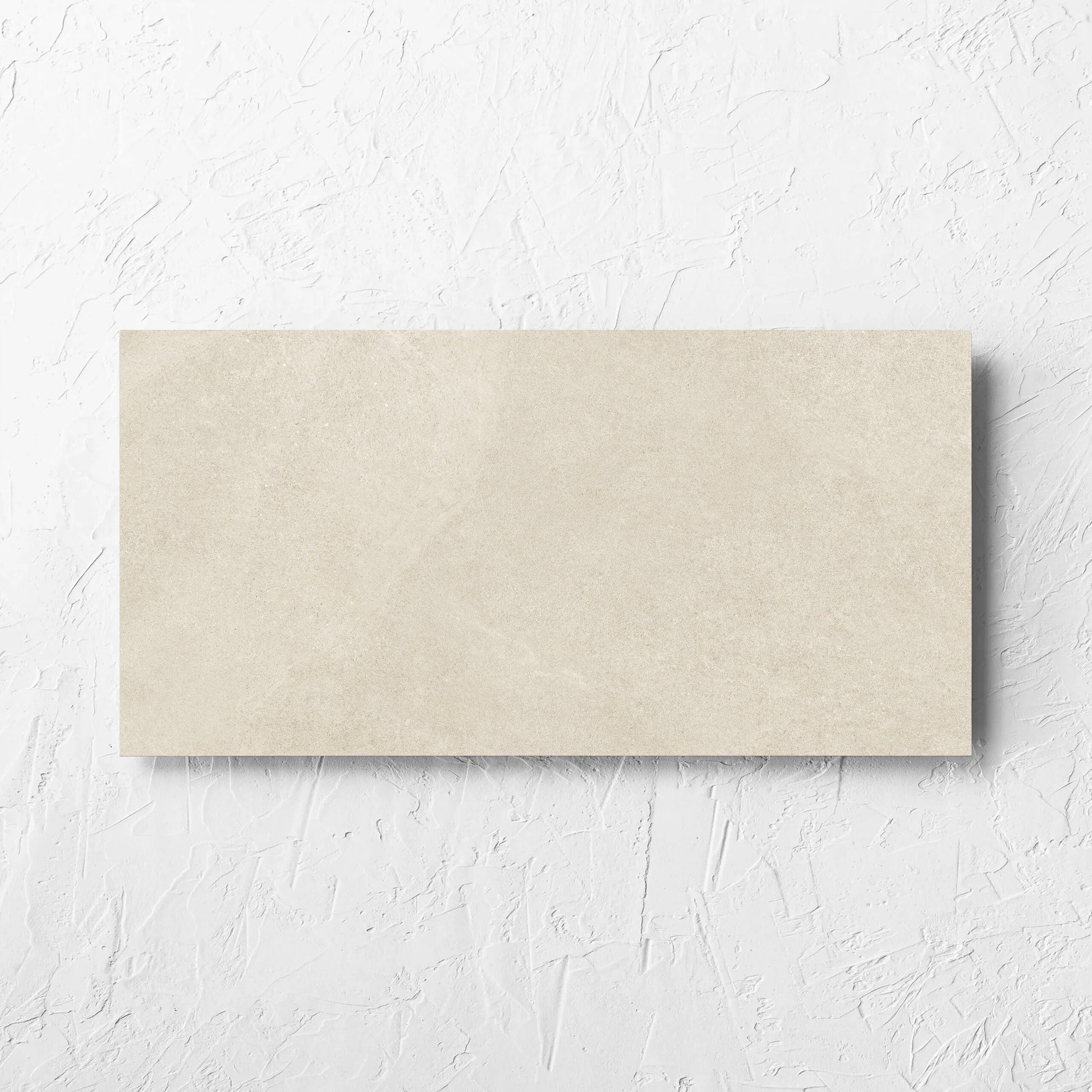 Fusion Beige Ultra Tech 300x600mm tile laid flat on a white rendered wall, showing the matt surface