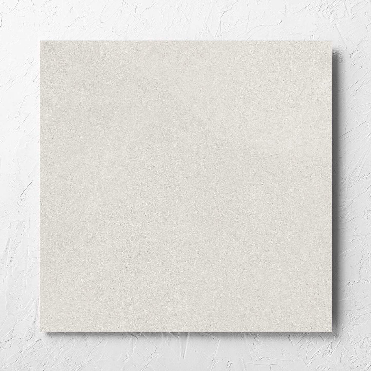 Fusion Bianco Ultra Tech 600x600mm tile laid flat on a white rendered wall, showing the matt surface