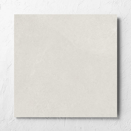 Fusion Bianco Ultra Tech 600x600mm tile laid flat on a white rendered wall, showing the matt surface