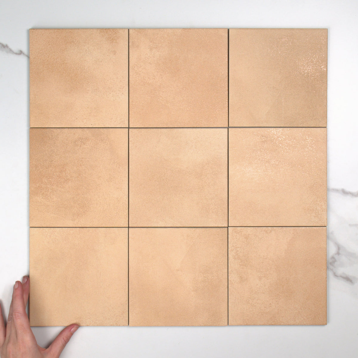Greenland Peach Anti-Slip 147x147mm top view, hand for scale