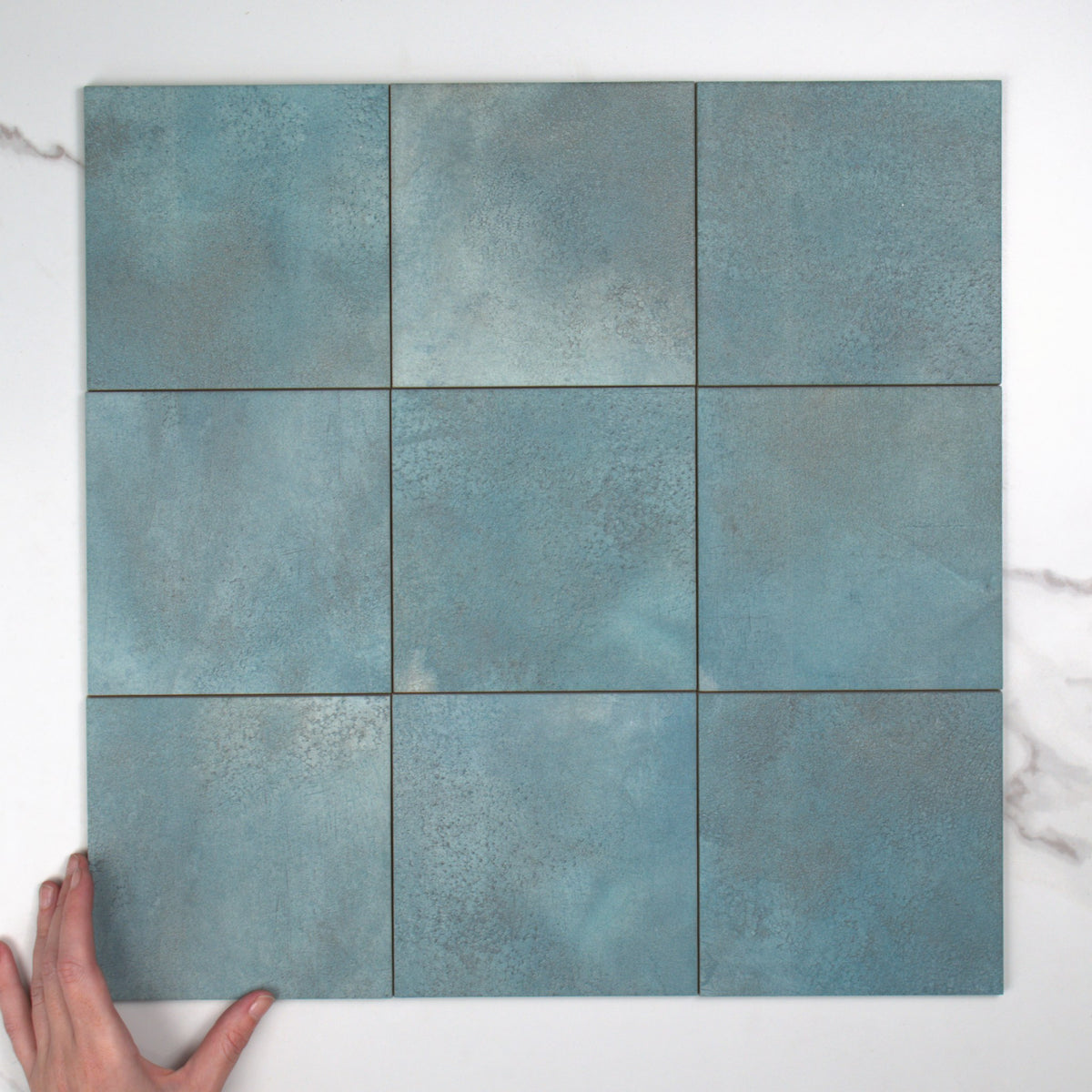 Greenland Teal Anti-Slip 147x147mm top view, hand for scale