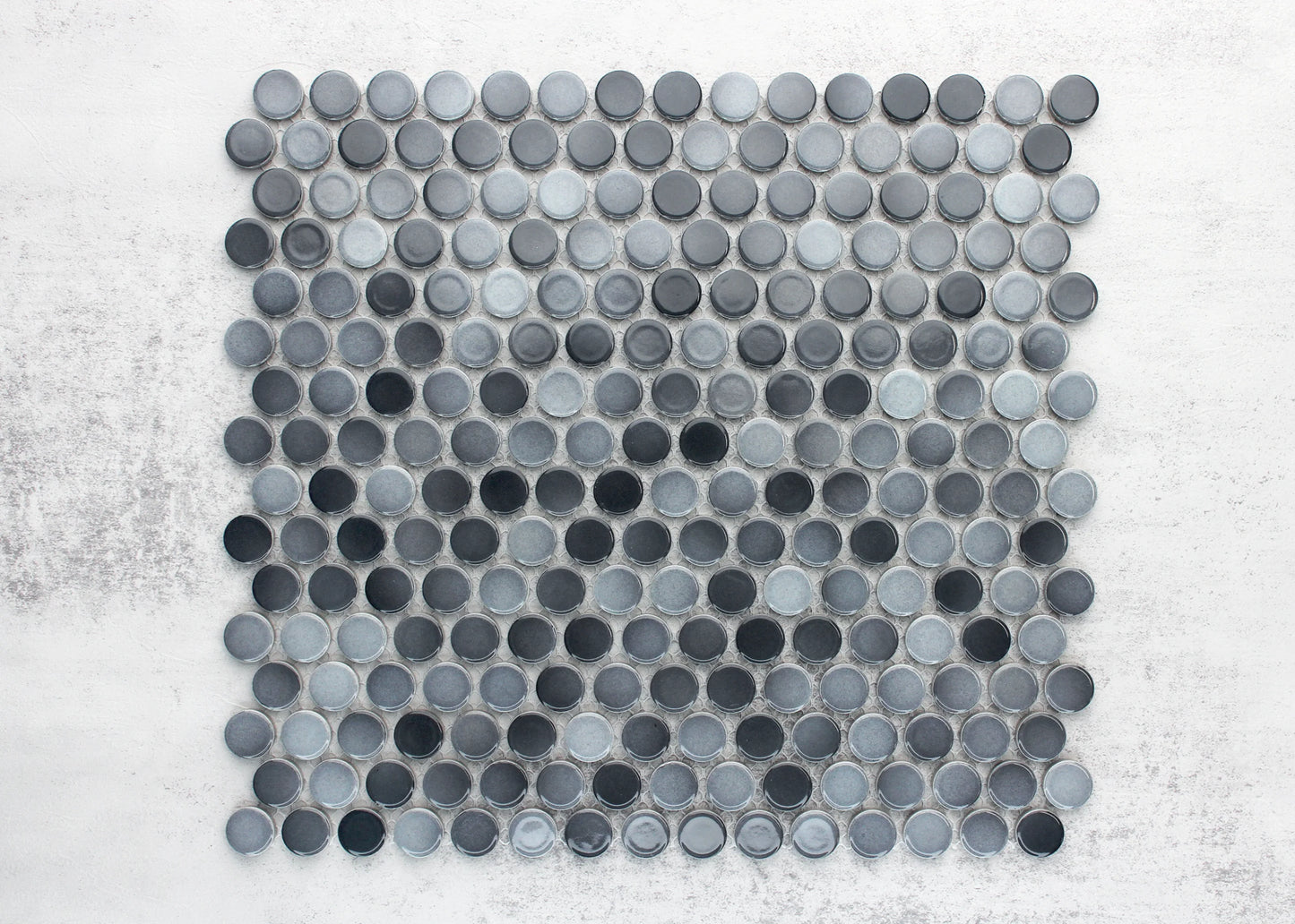 A flat lay pack shot of Grey Gloss Diameter Glazed Porcelain Penny Round 19mm tiles arranged in a mosaic sheet, showcasing mixed dark and light grey glazed circular coins on a white background.