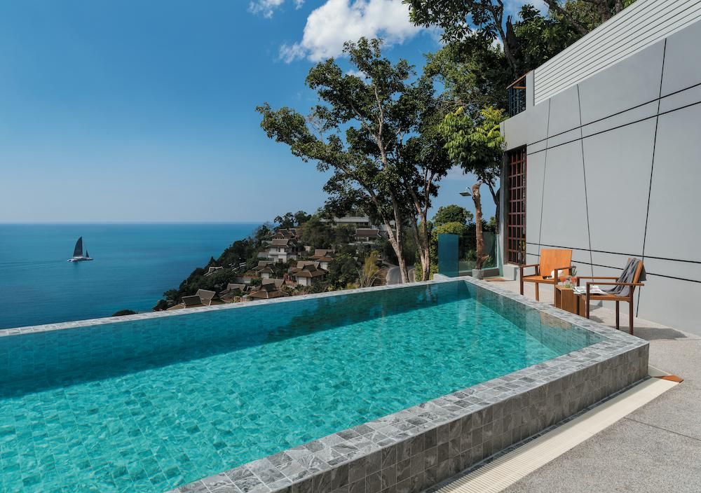 Hammond Grey Mosaic 97x97mm tiles clad the surround of a luxury infinity pool terrace overlooking a tropical ocean and hillside villas.