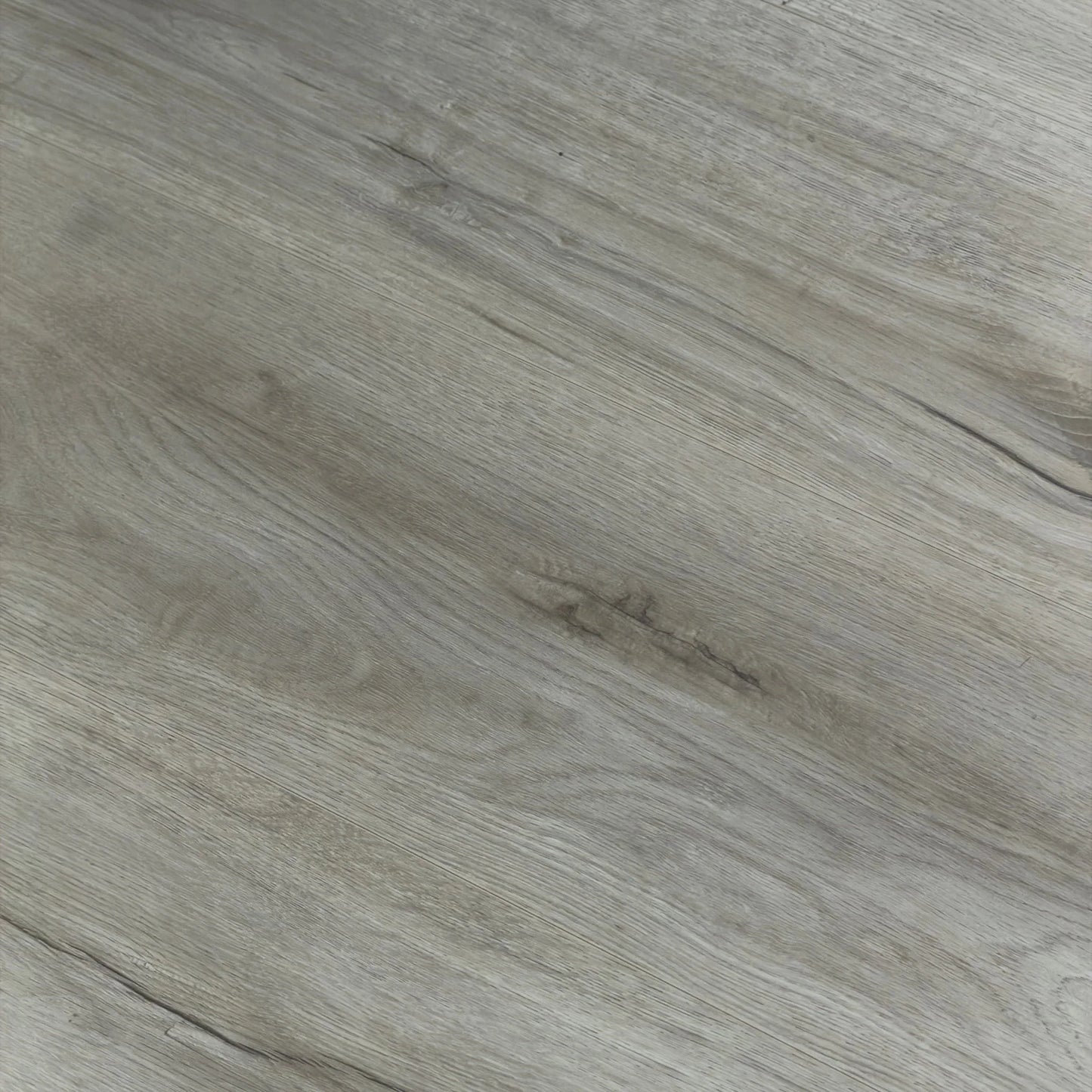 Close-up texture shot of Kandos Grey Urban Laminate 12mm Flooring 12mm showing realistic grey wood grain with subtle knot detail and fine linear surface texture.