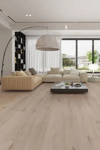 Kandos Grey Urban Laminate 12mm Flooring 12mm installed in a bright open-plan living room with cream sectional sofa and large pendant light.