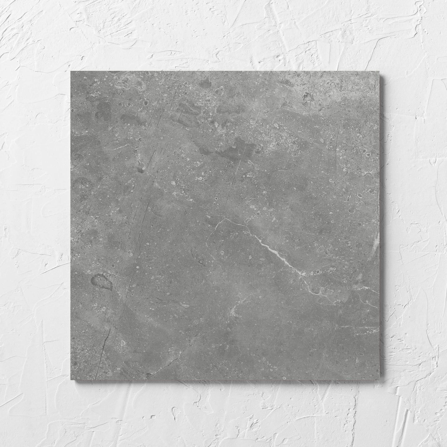 Kashmir Ash Matt 300x300mm tile laid flat on a white rendered wall, showing the matt surface