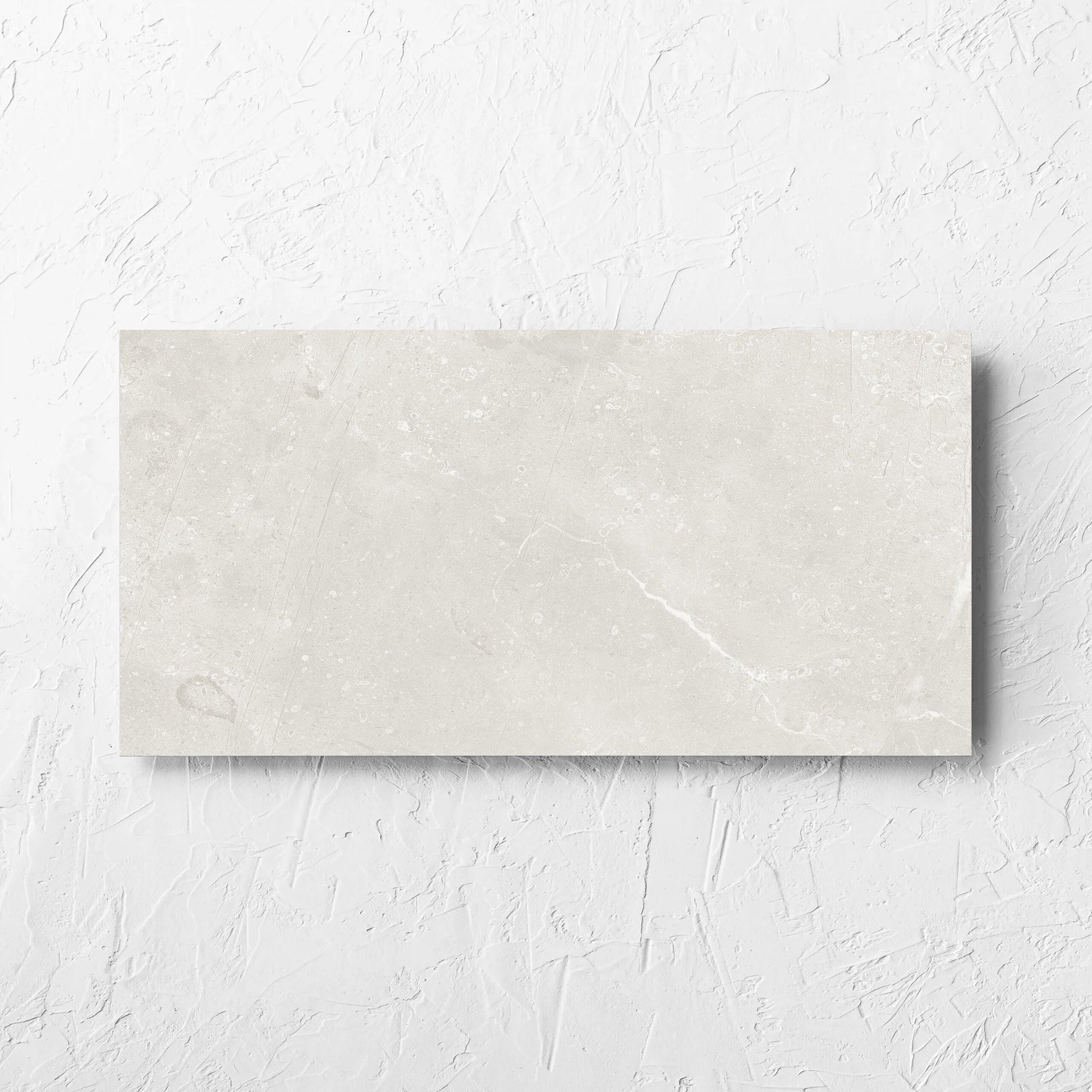 Kashmir Natural Matt 300x600mm tile laid flat on a white rendered wall, showing the matt surface