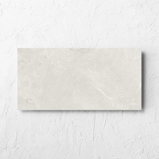 Kashmir Natural Matt 300x600mm tile laid flat on a white rendered wall, showing the matt surface