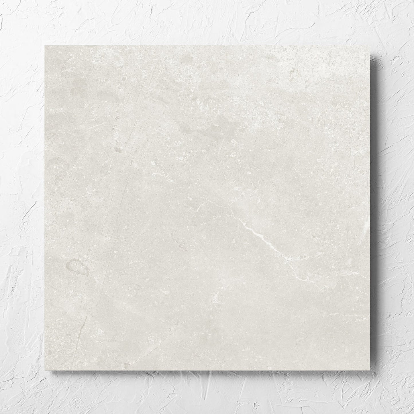Kashmir Natural Matt 600x600mm tile laid flat on a white rendered wall, showing the matt surface