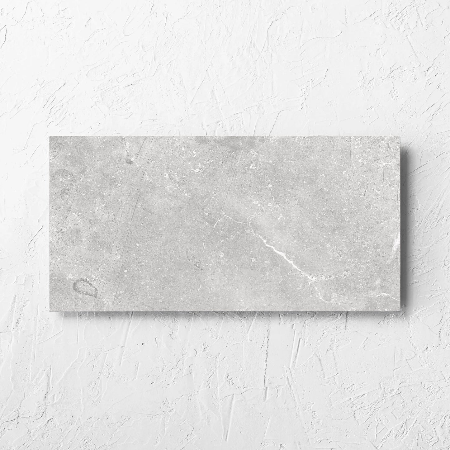 Kashmir Stone Matt 300x600mm tile laid flat on a white rendered wall, showing the matt surface