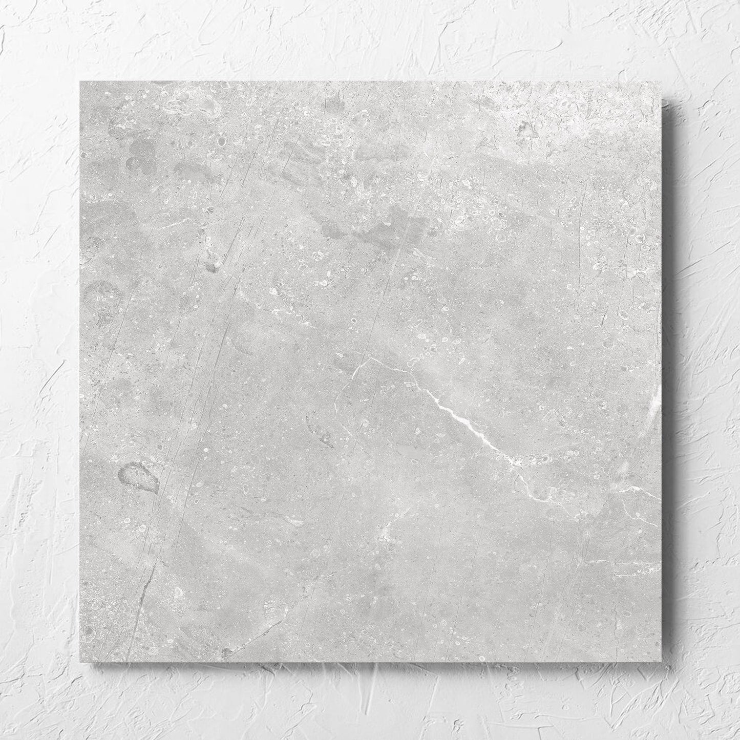 Kashmir Stone Matt 600x600mm tile laid flat on a white rendered wall, showing the matt surface