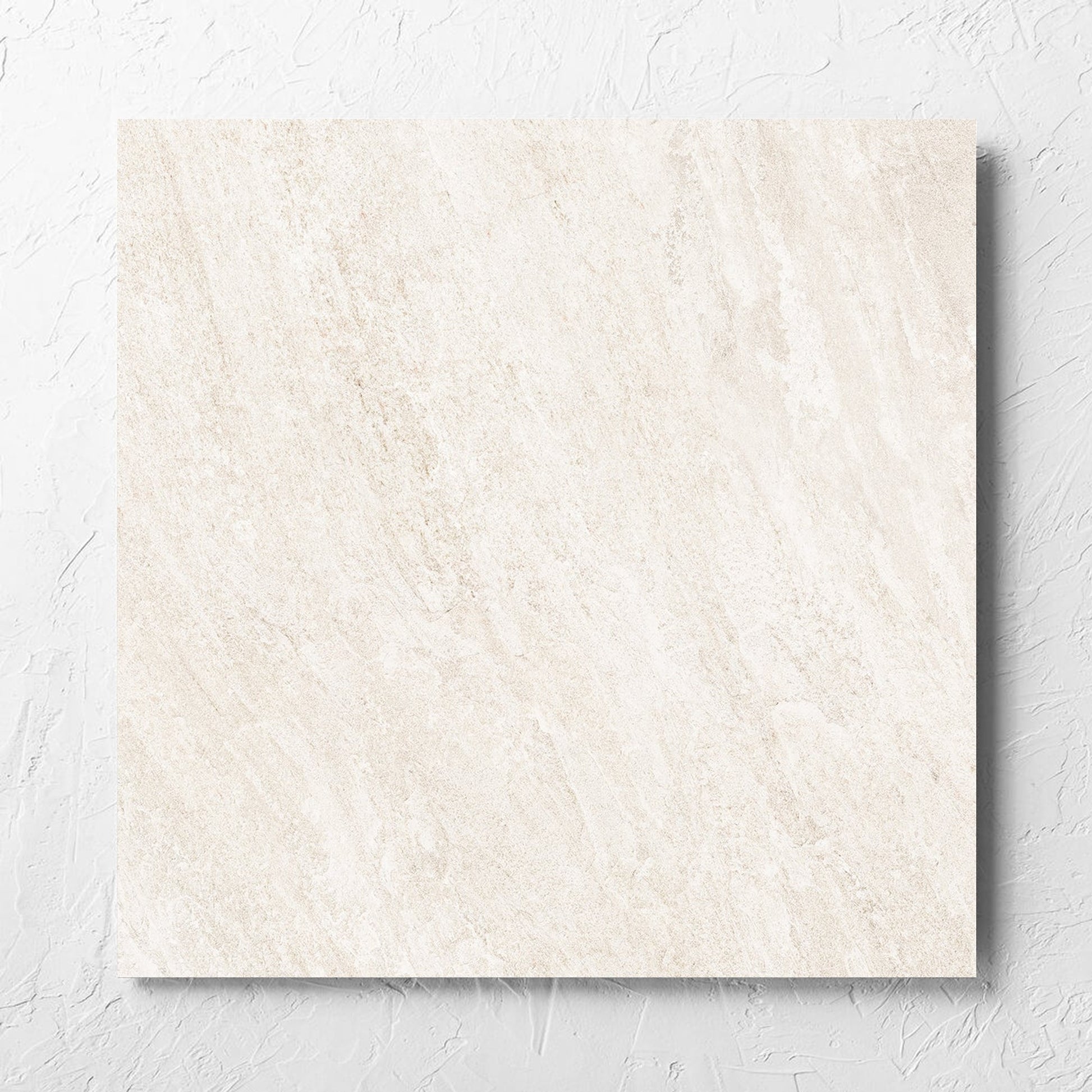 Kora Stone Chalk Grip 600x600mm tile laid flat on a white rendered wall, showing the matt surface