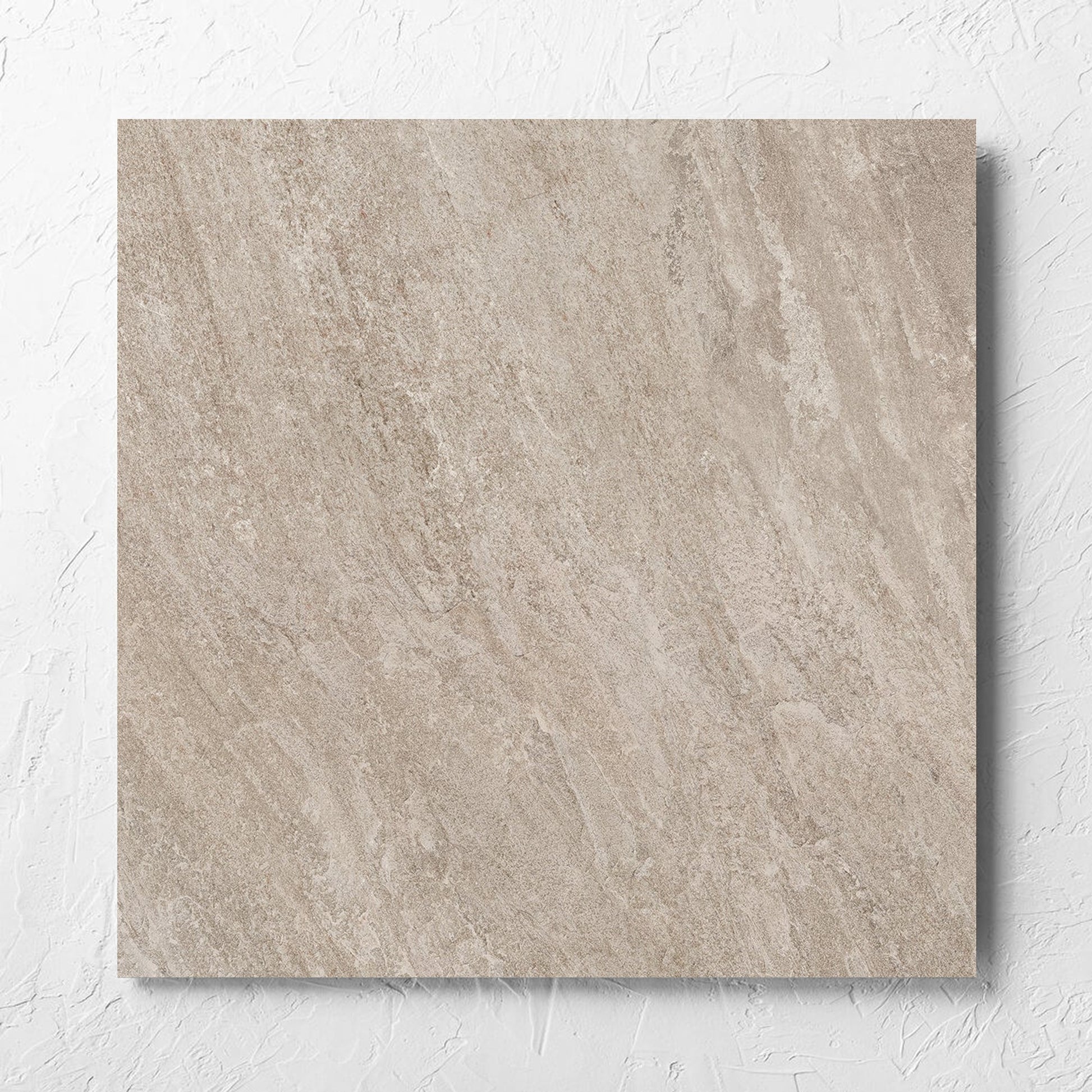 Kora Stone Clay Matt 600x600mm tile laid flat on a white rendered wall, showing the matt surface