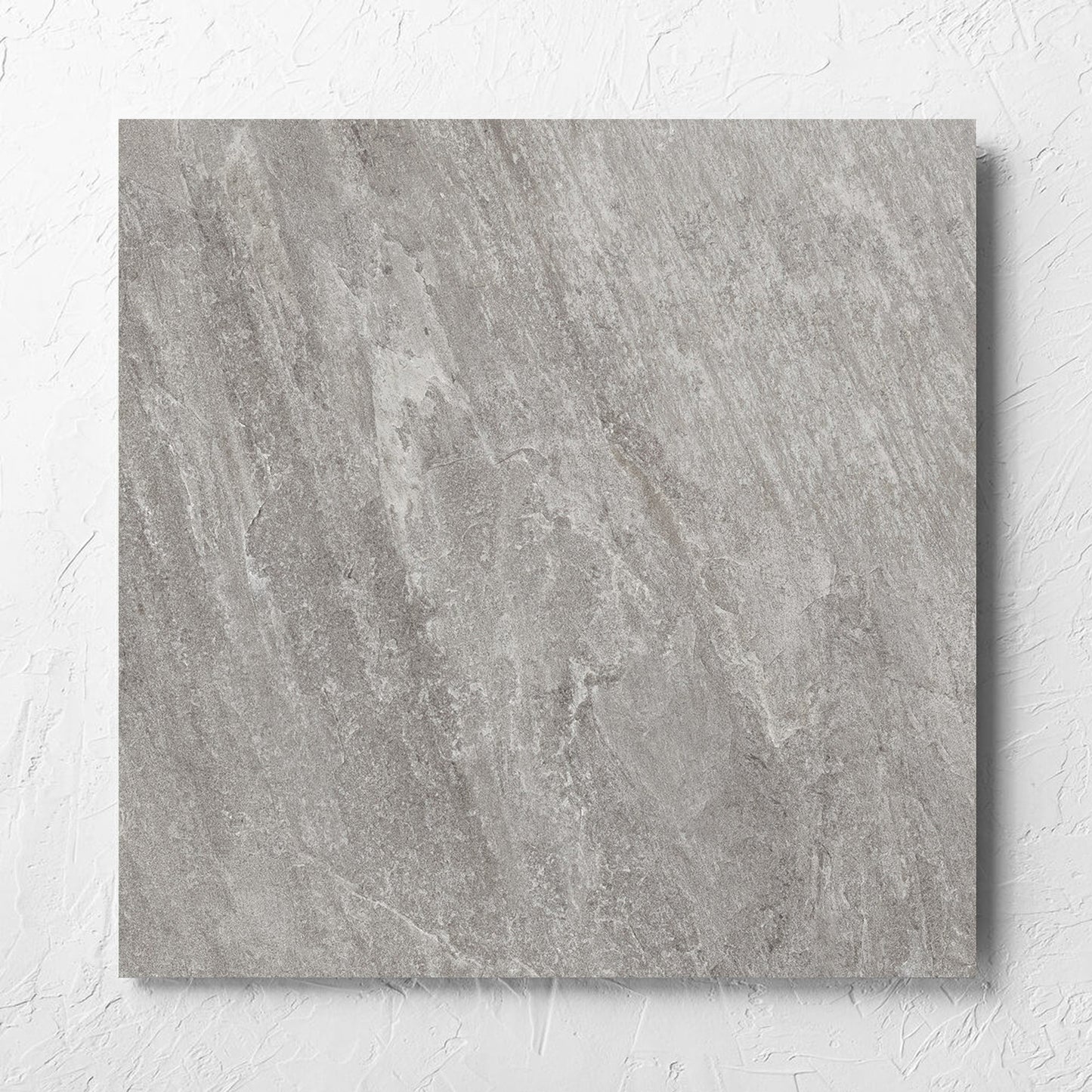 Kora Stone Shale Matt 600x600mm tile laid flat on a white rendered wall, showing the matt surface