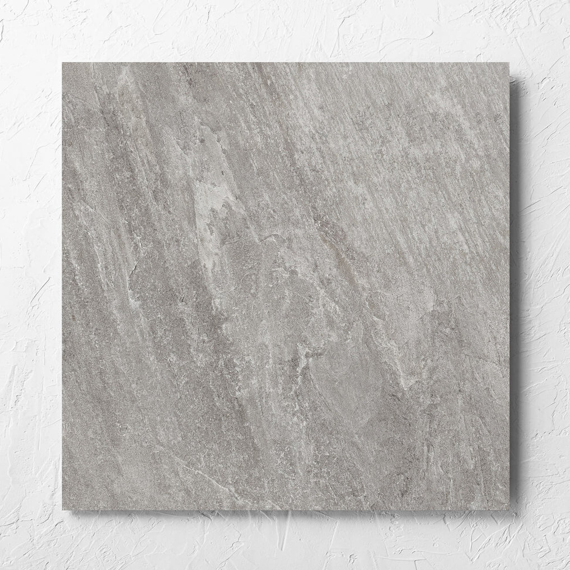 Kora Stone Shale Matt 600x600mm tile laid flat on a white rendered wall, showing the matt surface