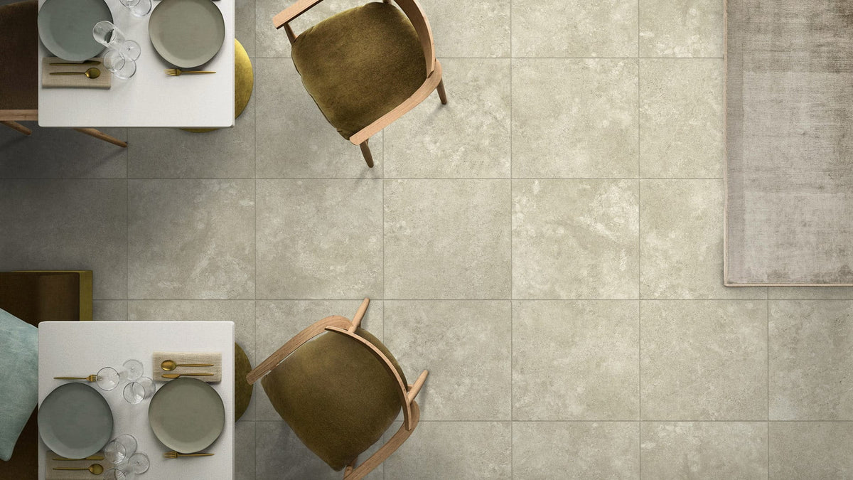 Kross Light Bianco Matt Smooth Grip 600x600mm installed as a dining room floor with olive green chairs and white table settings viewed from above.