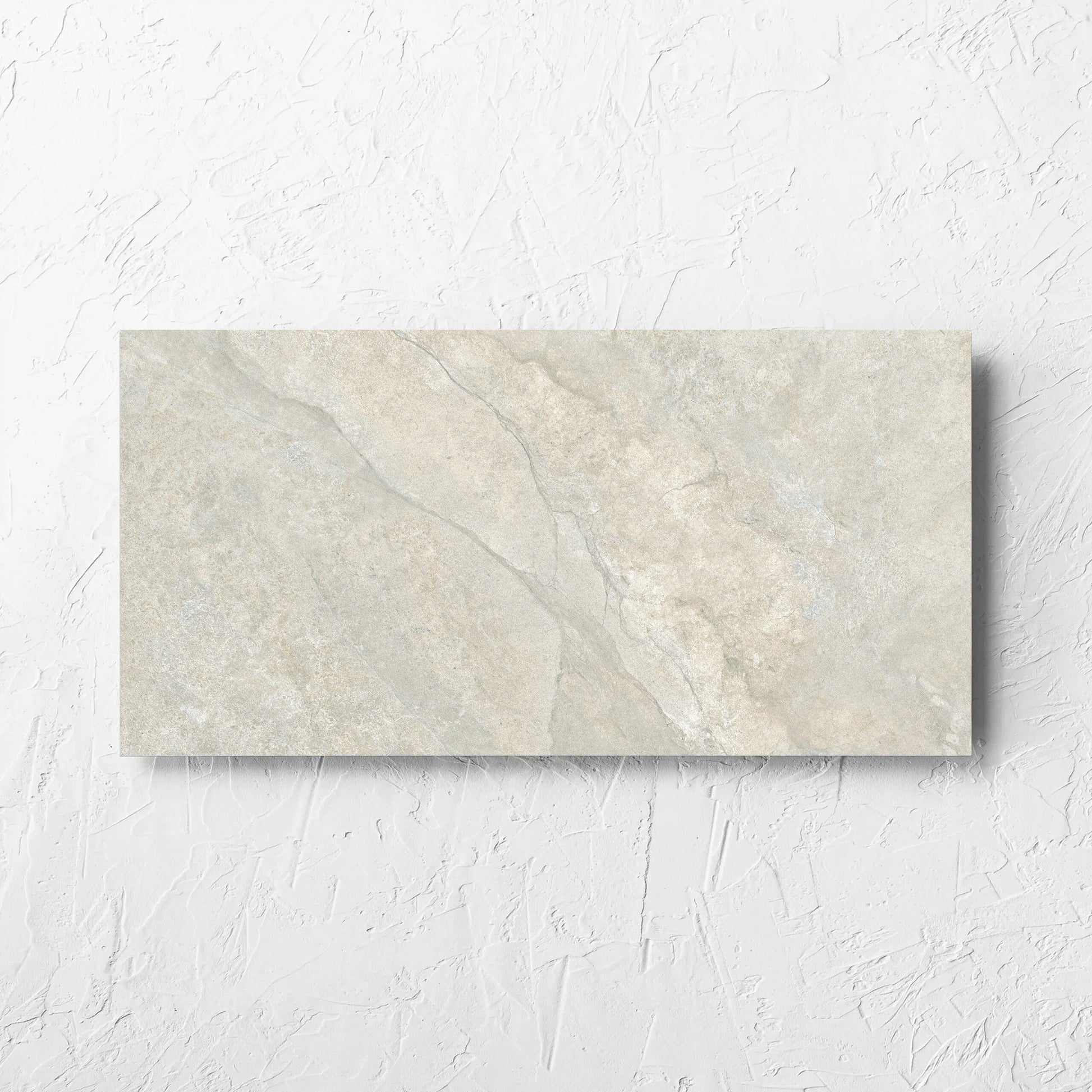 Lakestone Grey Matt 300x600mm tile laid flat on a white rendered wall, showing the matt surface