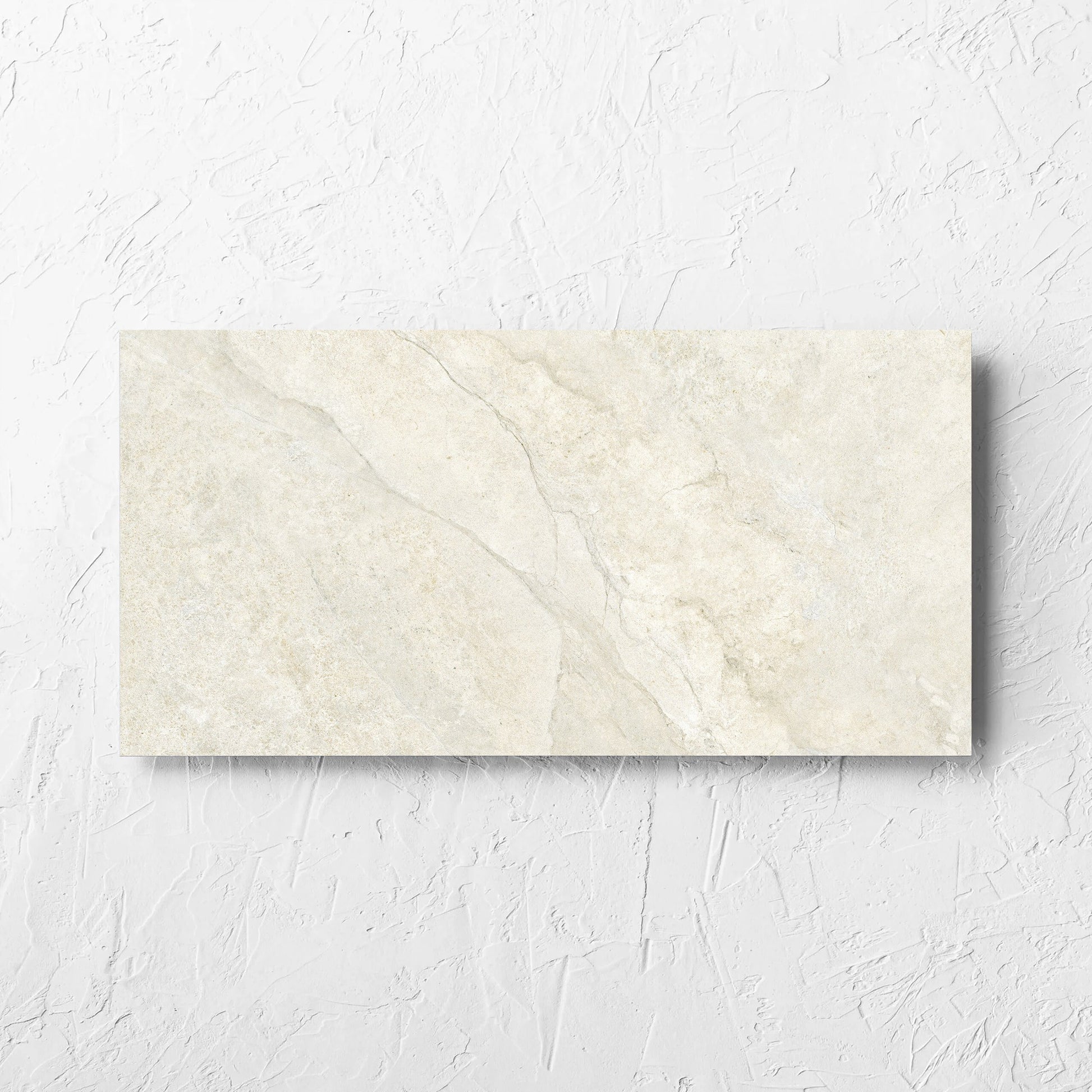 Lakestone Sand Matt 300x600mm tile laid flat on a white rendered wall, showing the matt surface