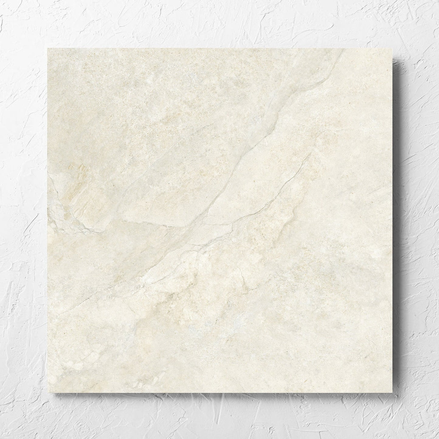 Lakestone Sand Matt 600x600mm tile laid flat on a white rendered wall, showing the matt surface