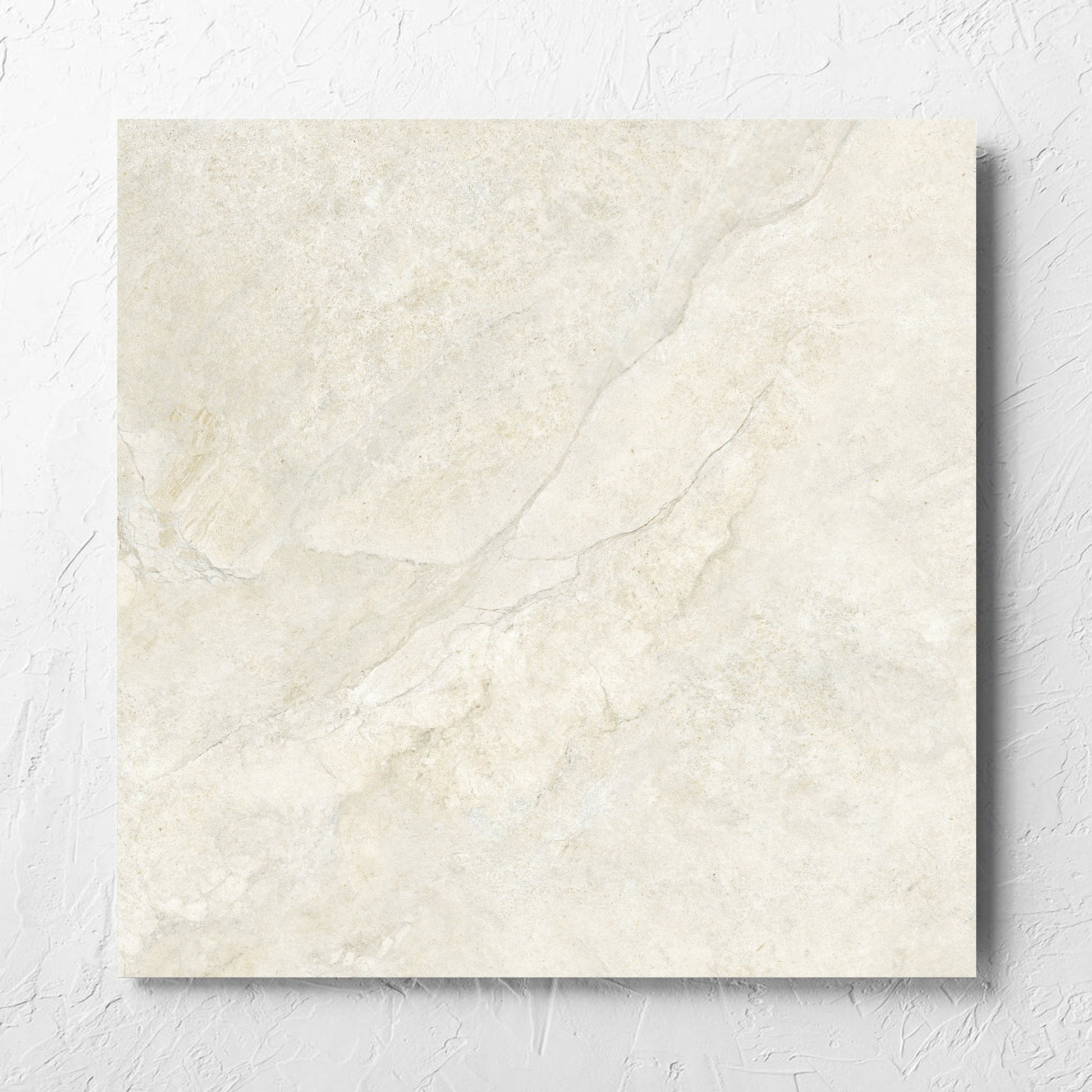 Lakestone Sand Matt 600x600mm tile laid flat on a white rendered wall, showing the matt surface