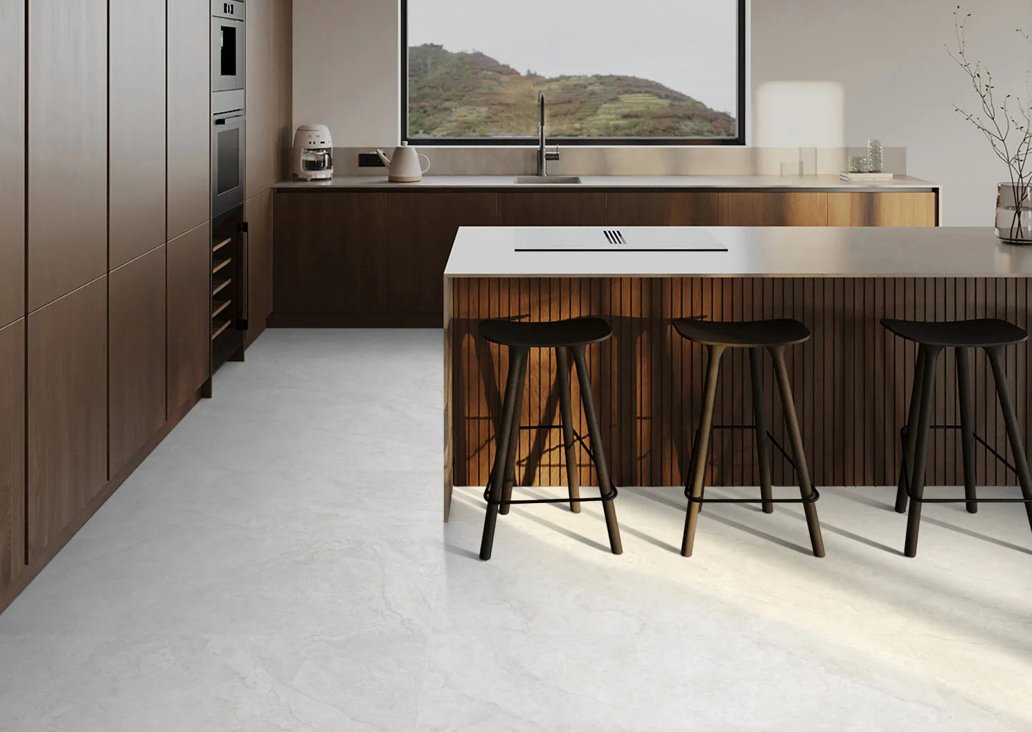 Lakestone White Matt 600x1200mm porcelain tiles laid on a open-plan kitchen floor featuring a timber island with black bar stools and large window.