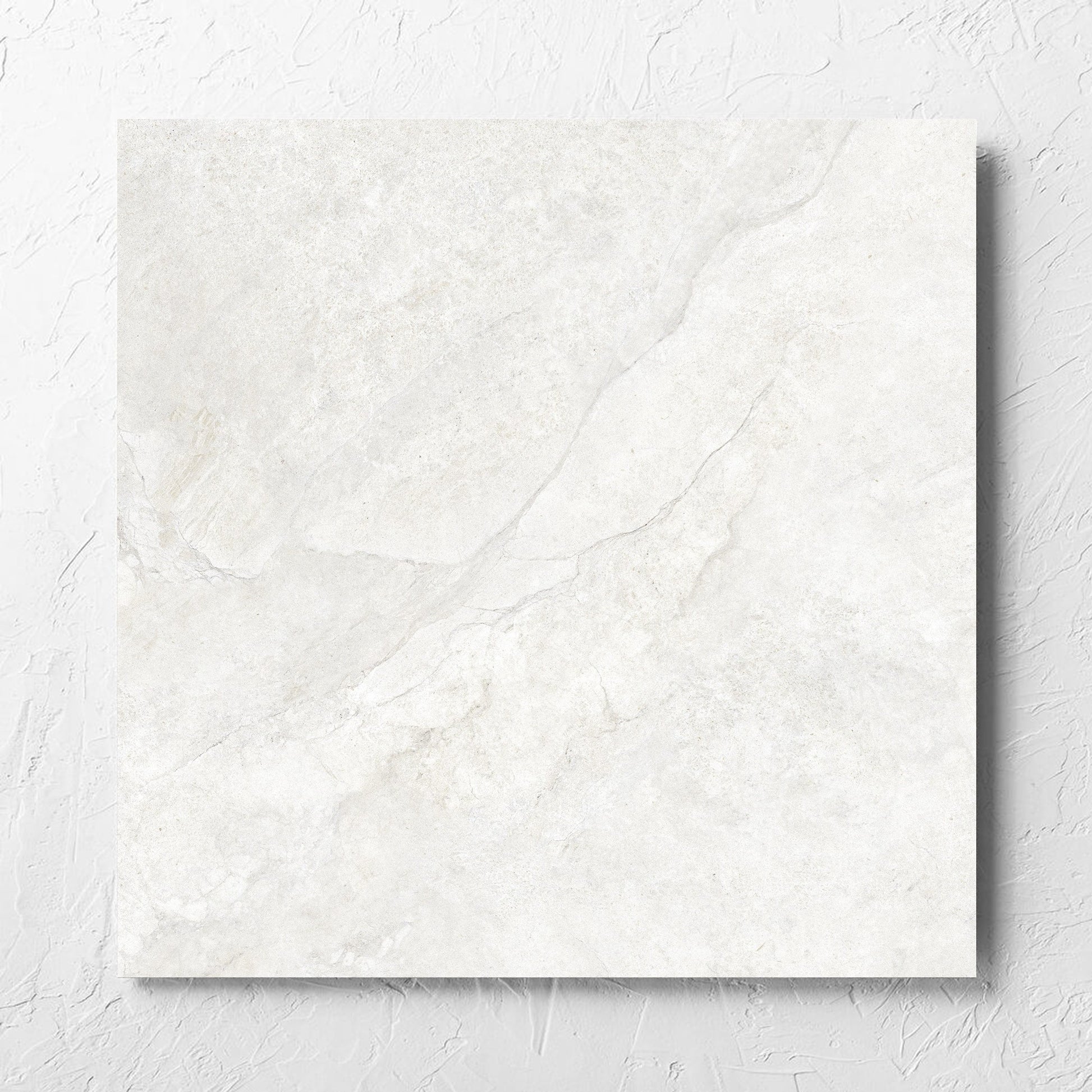 Lakestone White Matt 600x600mm tile laid flat on a white rendered wall, showing the matt surface