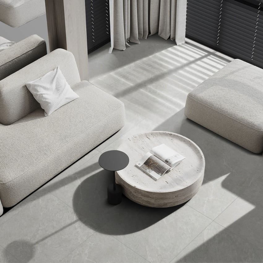 Lava Ash Amber 600x1200mm large format grey tiles installed as a polished living room floor beneath a minimalist modular sofa and stone coffee table.