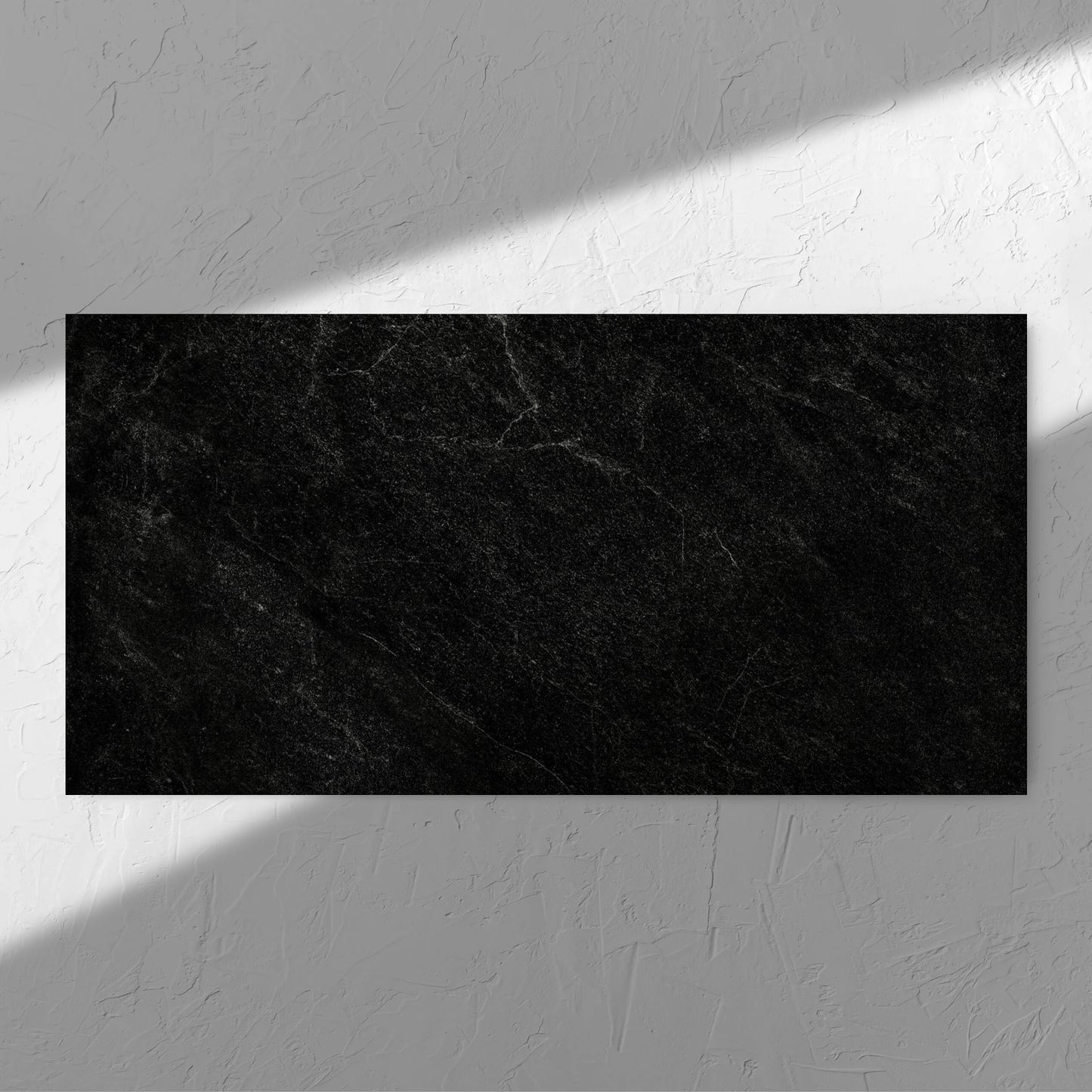 Lava Black Amber 600x1200mm tile in soft natural window light, showing the black surface