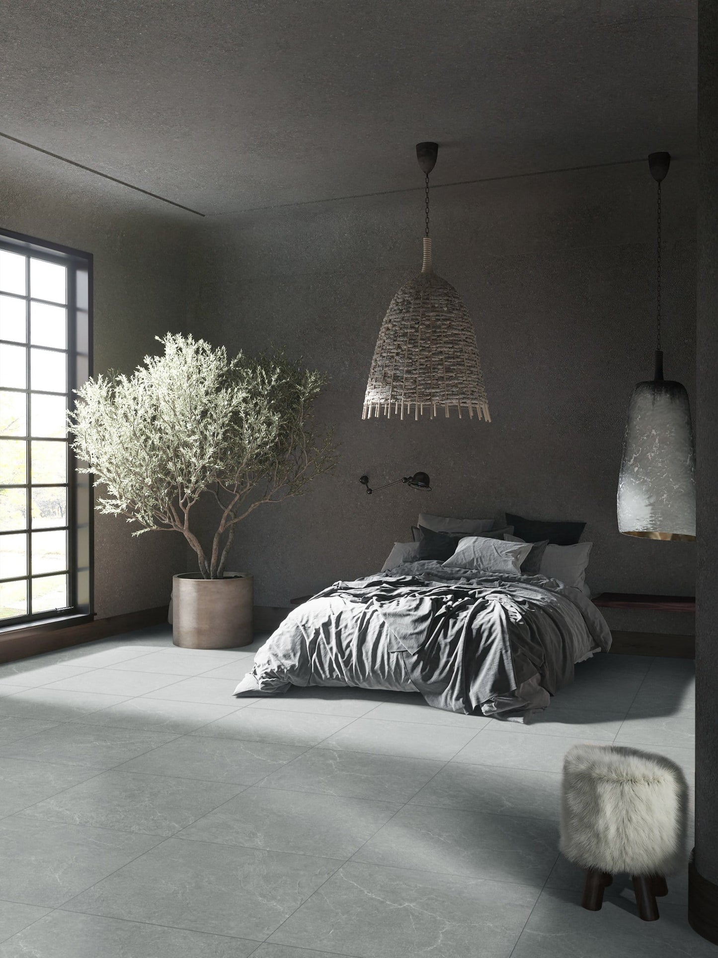 Lava Grey Amber 600x1200mm large-format grey tiles laid on a moody bedroom floor beside a potted olive tree and woven pendant lights.