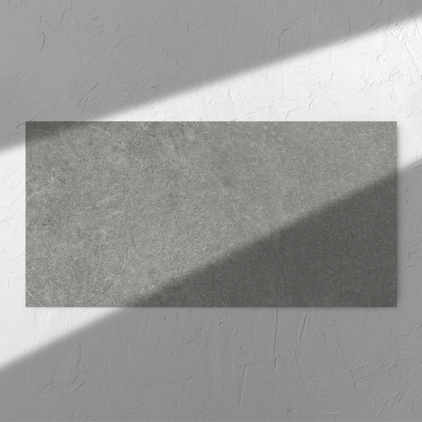 Lava Grey Amber 600x1200mm tile in soft natural window light, showing the grey surface